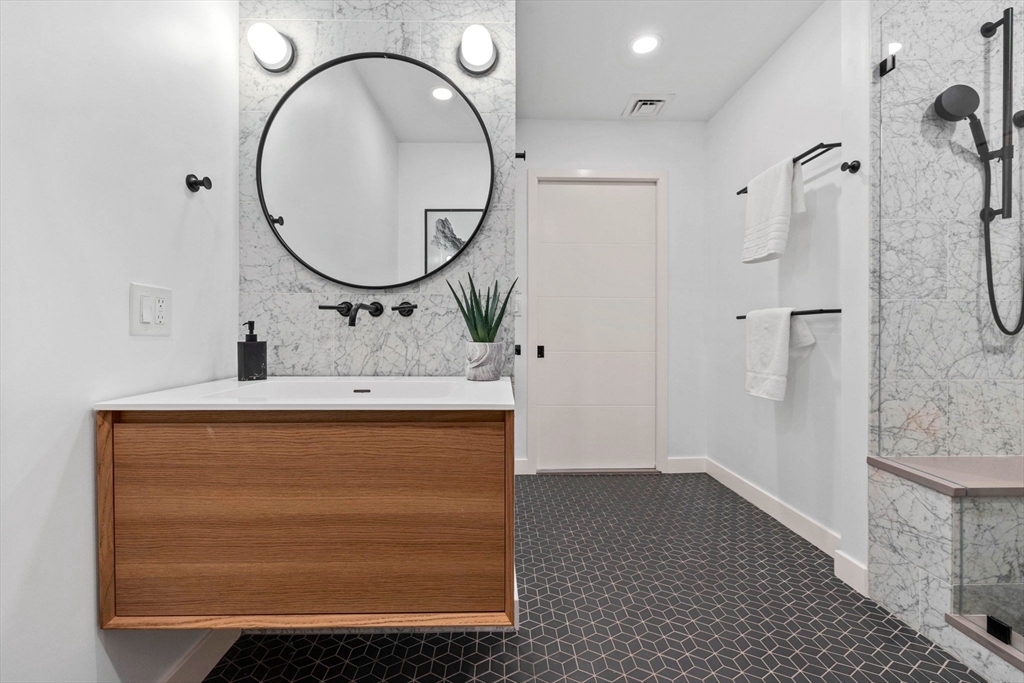 9 Medford Street, Unit PH3 Somerville, MA 02143 - Photo 15 of 30 a bathroom with a sink a mirror and a shower