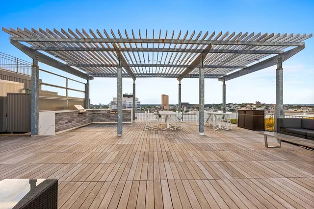 a swimming pool with lawn chairs and wooden floor