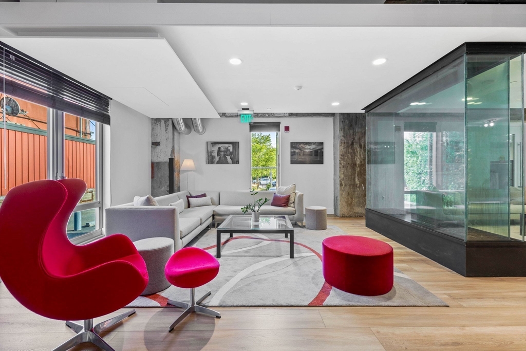 9 Medford Street, Unit PH3 Somerville, MA 02143 - Photo 23 of 30 a living room with furniture a rug and white walls