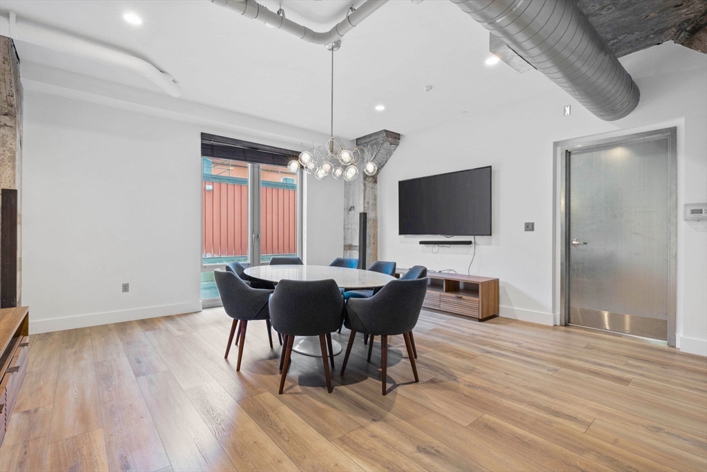 9 Medford Street, Unit PH3 Somerville, MA 02143 - Photo 28 of 30 a view of a dining room with furniture and wooden floor