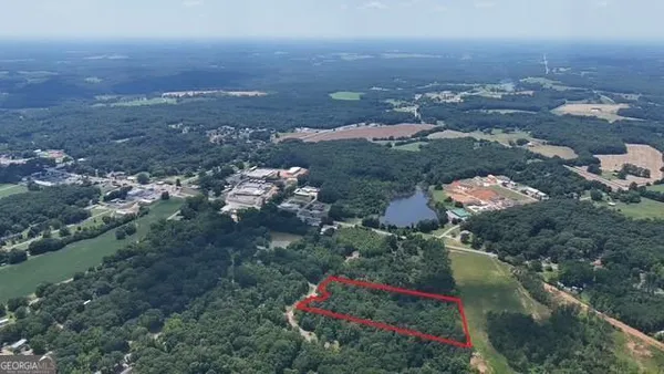 an aerial view of house with yard and mountain view in back