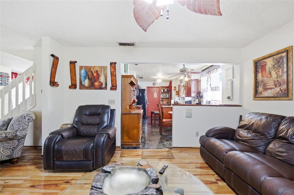 3027 Queens Gate Road Orlando, FL 32818 - Photo 14 of 34 a living room with furniture and a couch