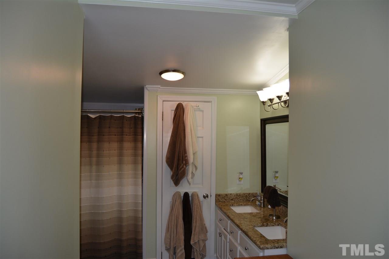 3056 Seven Paths Road Louisburg, NC 27549 - Photo 20 of 29 This large bathroom has room for everyone. Features granite counter tops, updated flooring, tub & shower, lighting and toilet.