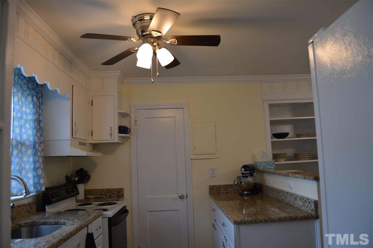 3056 Seven Paths Road Louisburg, NC 27549 - Photo 9 of 29 Kitchen with granite counter tops, dishwasher, range and refrigerator.
