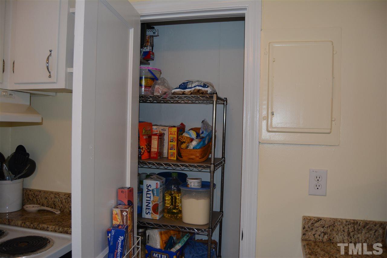 3056 Seven Paths Road Louisburg, NC 27549 - Photo 10 of 29 This custom pantry gives you added space. The cabinet slides back and forth.