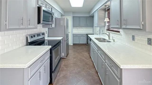 a kitchen with stainless steel appliances granite countertop a sink and cabinets