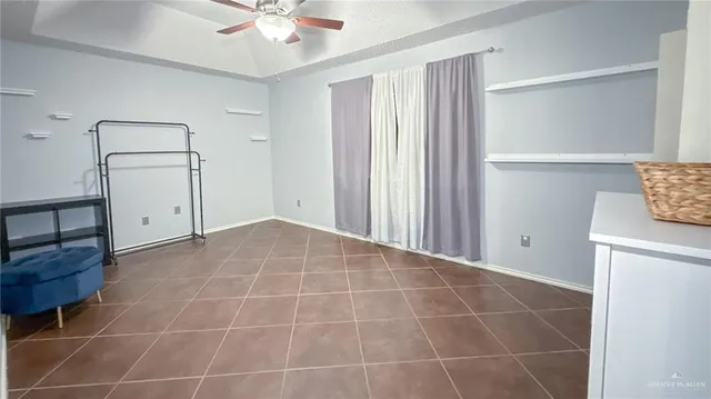 a view of an empty room with cabinet and hardwood floor