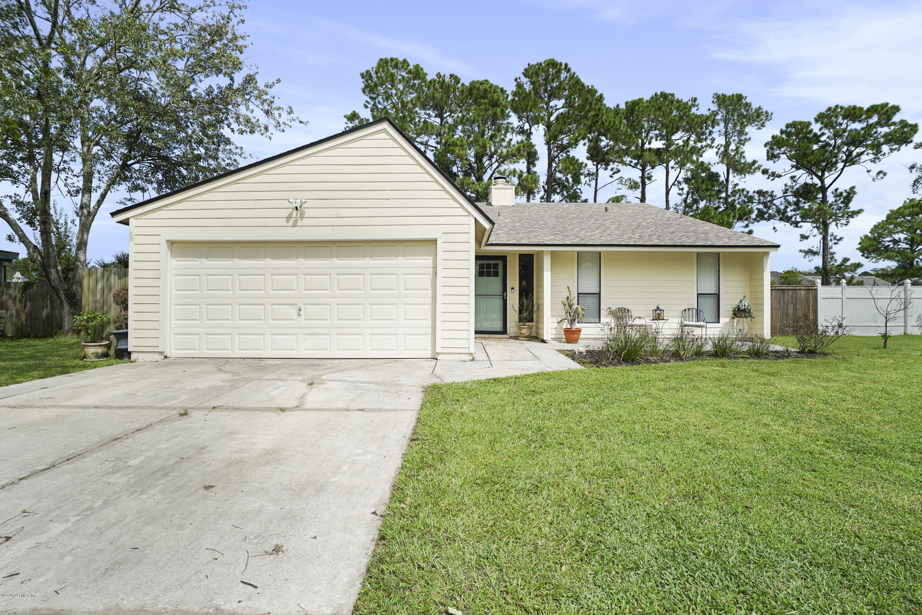 2465 Wattle Tree Road West Jacksonville, FL 32246 - Photo 1 of 31 a front view of a house with a garden and plants