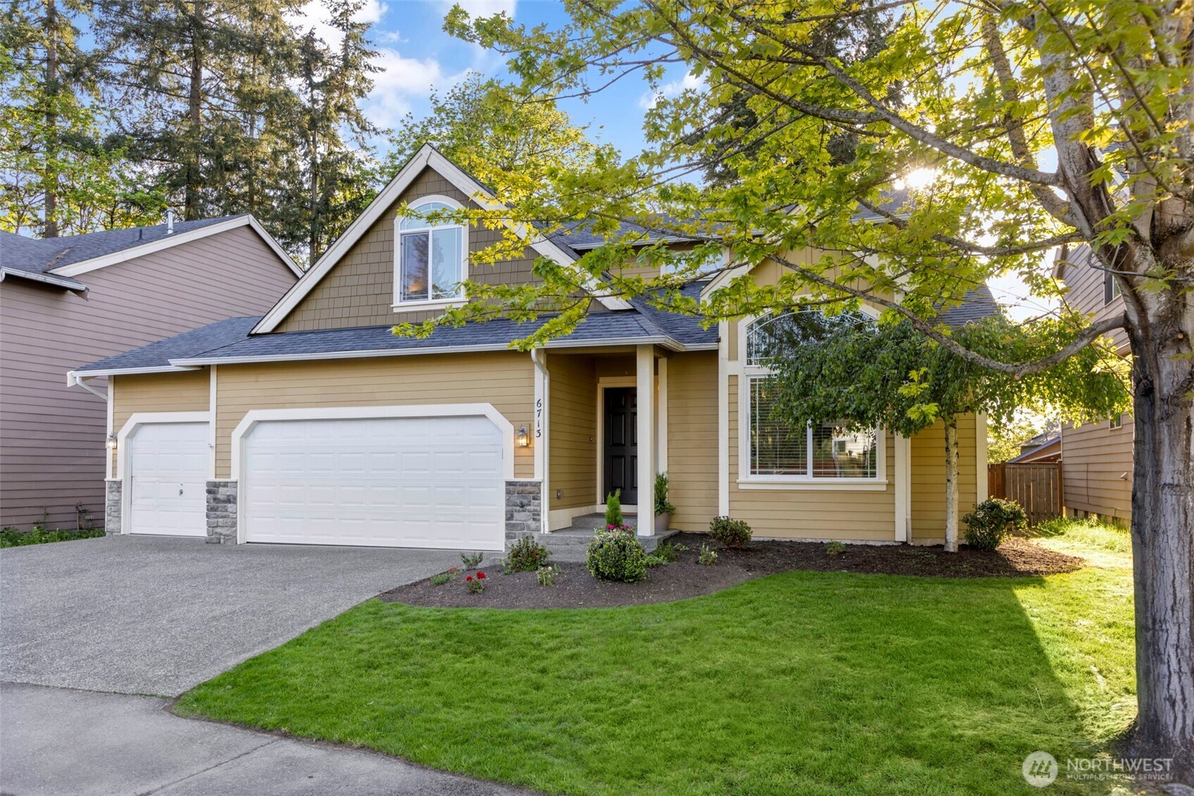 6713 Southeast 5th Street Renton, WA 98059 - Photo 1 of 1 a front view of a house with a yard and garage