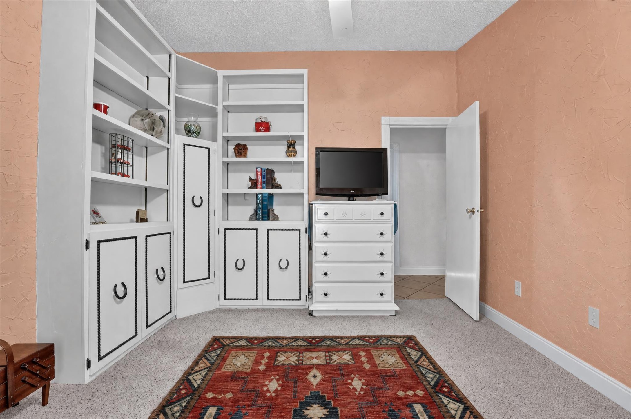 317 Rae Lane Jarrell, TX 76537 - Photo 39 of 40 Built-in shelving and cabinetry offer abundant storage within this inviting room.