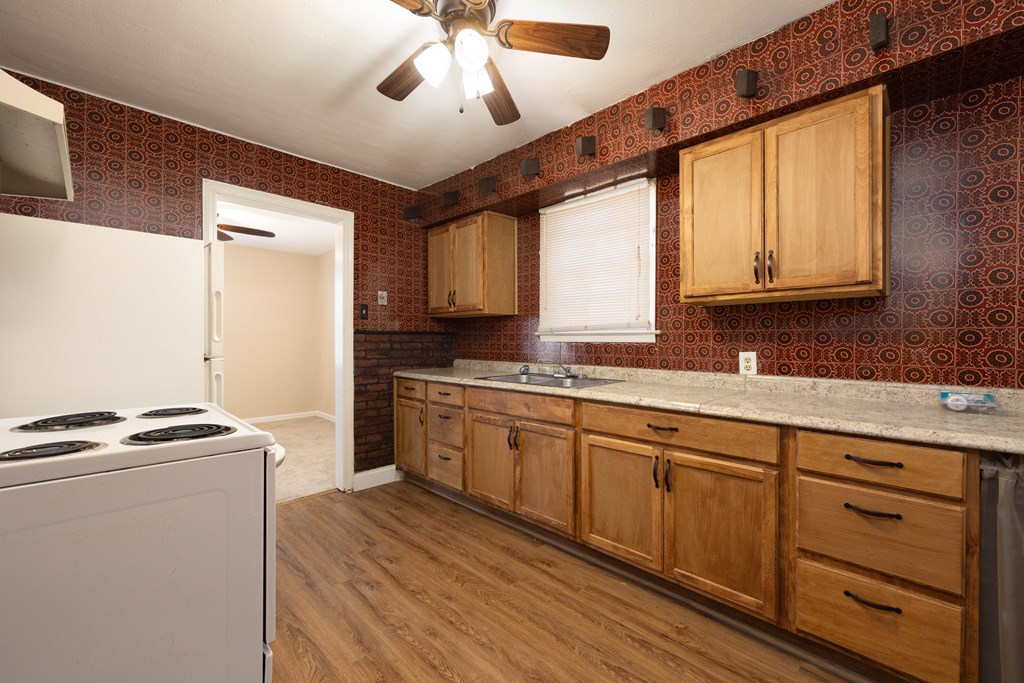 2254 South Lumpkin Road Columbus, GA 31903 - Photo 12 of 16 a kitchen with granite countertop cabinets stainless steel appliances a sink and a window