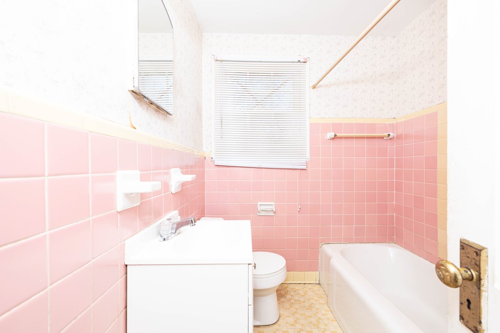 2254 South Lumpkin Road Columbus, GA 31903 - Photo 9 of 16 a bathroom with a sink a toilet a mirror and shower