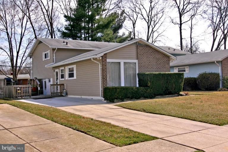 3915 Setonhurst Road Pikesville, MD 21208 - Photo 1 of 17 a front view of a house with a yard and garage