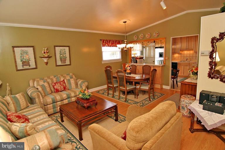 3915 Setonhurst Road Pikesville, MD 21208 - Photo 5 of 17 a living room with furniture a lamp and large window