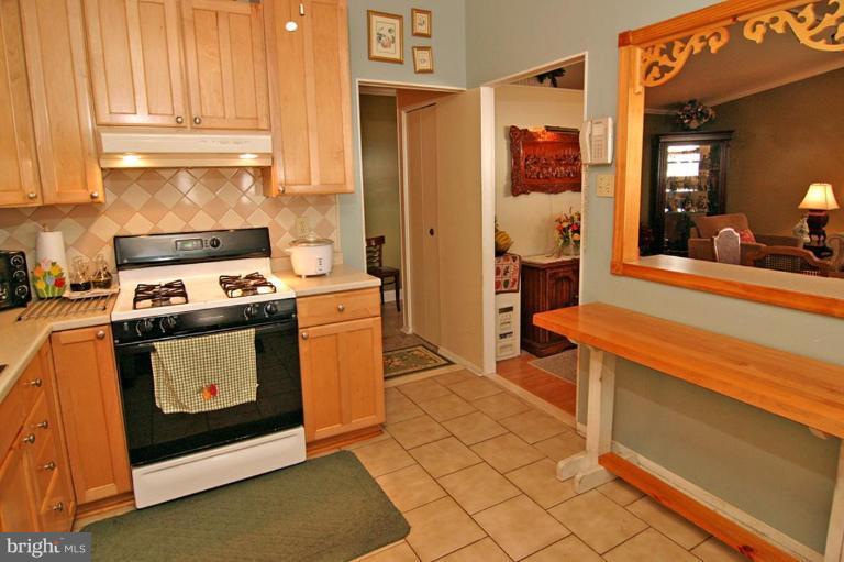 3915 Setonhurst Road Pikesville, MD 21208 - Photo 6 of 17 a kitchen with stainless steel appliances granite countertop a stove and a refrigerator