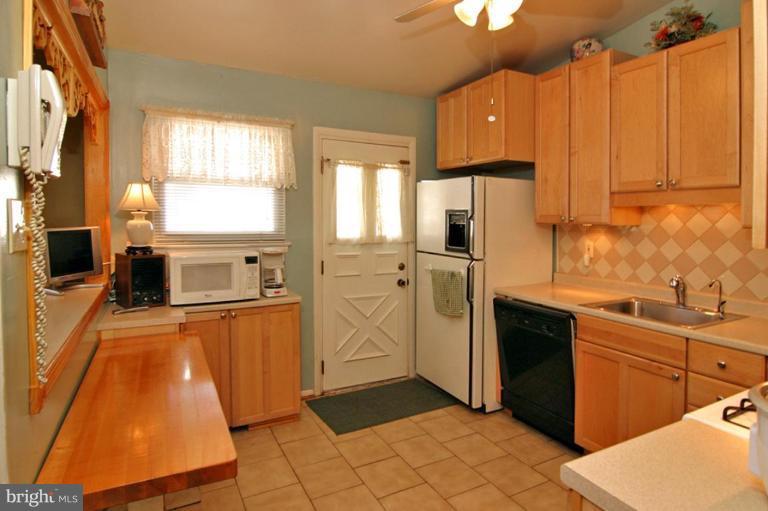 3915 Setonhurst Road Pikesville, MD 21208 - Photo 7 of 17 a kitchen with stainless steel appliances a stove sink and refrigerator
