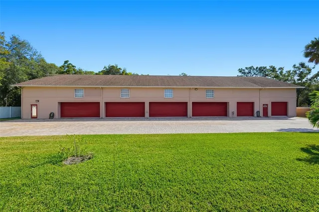 a view of a garage with a white house