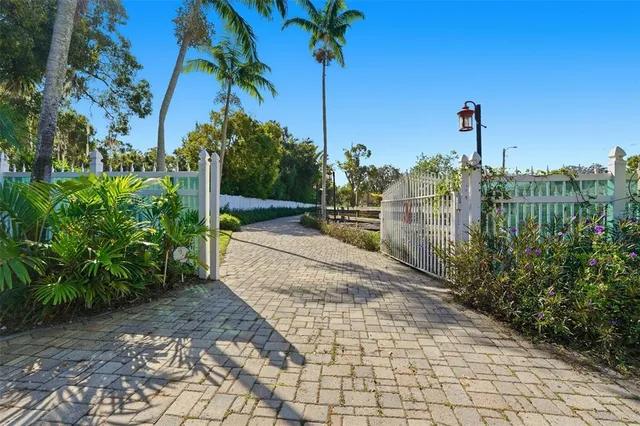 a view of a street with potted plants