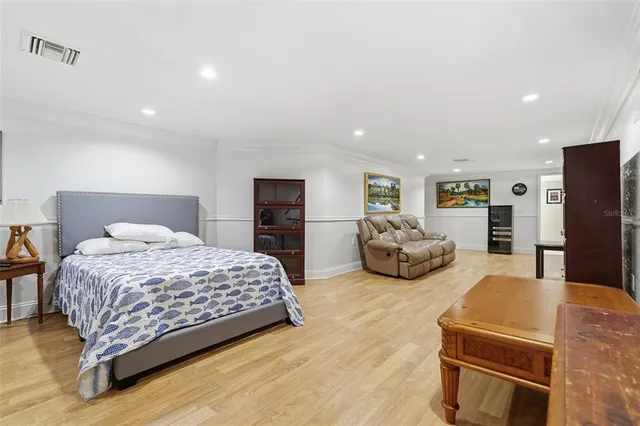 a living room with couches a fireplace and kitchen view
