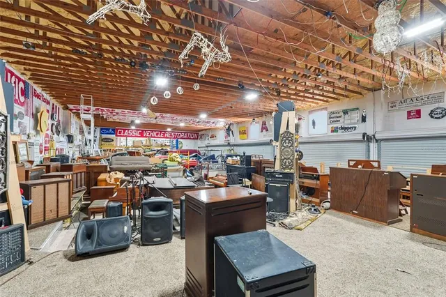 a spacious bedroom with a bed a couch and dresser