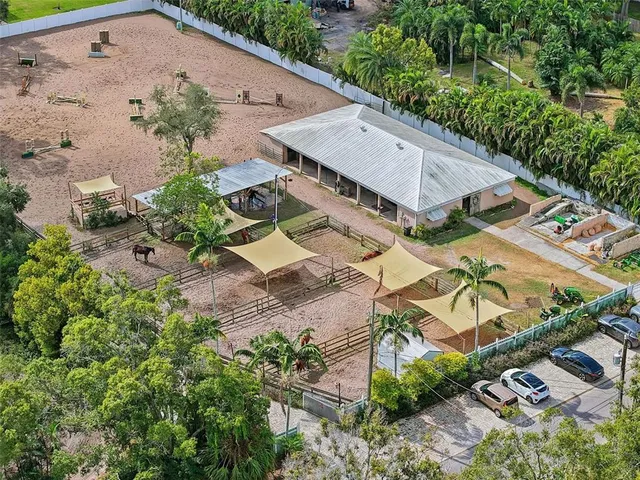 an aerial view of a house with a yard basket ball court and outdoor seating