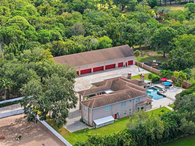 an aerial view of a house with garden space and outdoor seating