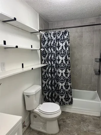 a bathroom with a toilet and a bathtub
