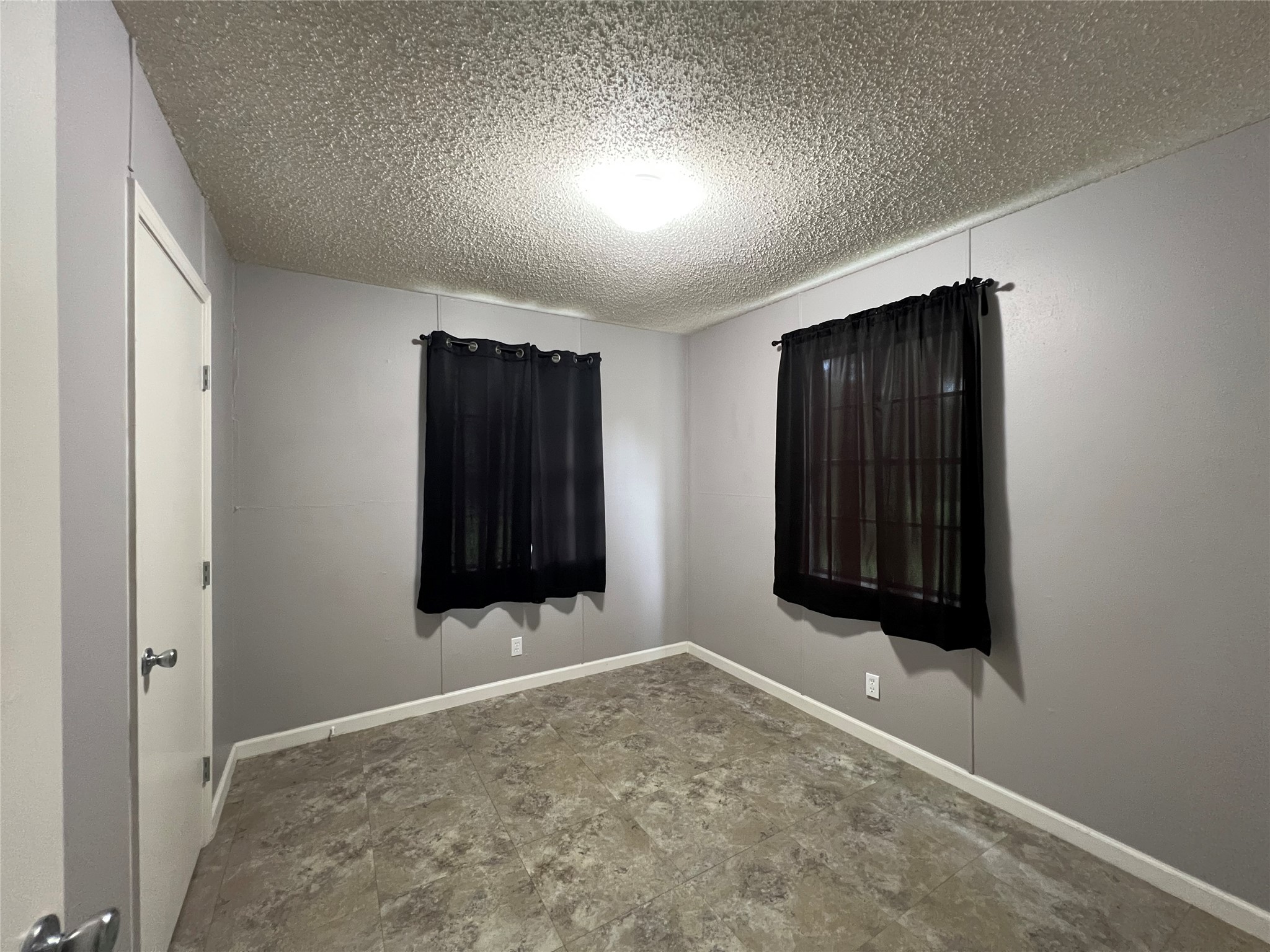 806 West 8th Street Taylor, TX 76574 - Photo 8 of 11 an empty room with window and stairs