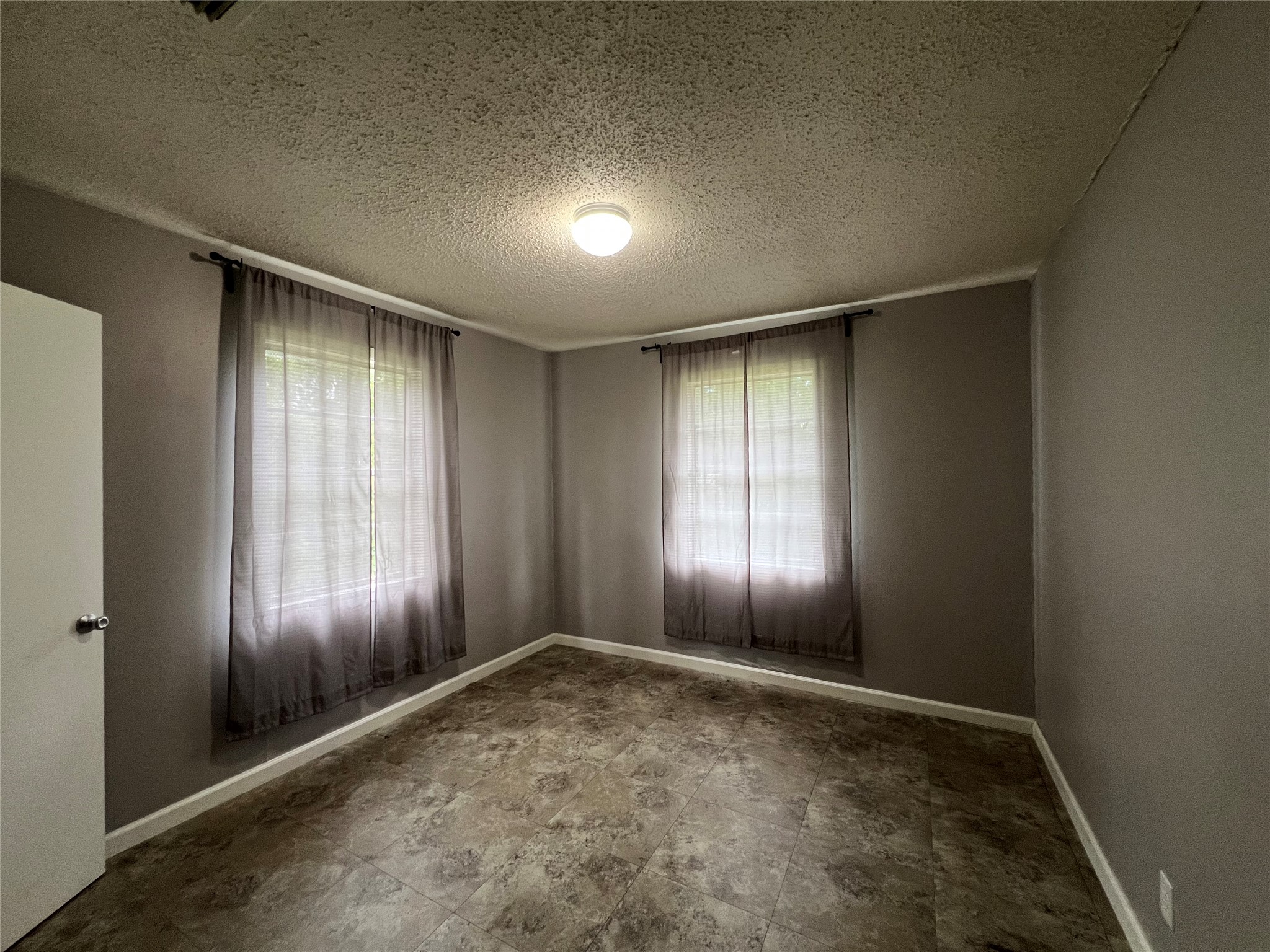806 West 8th Street Taylor, TX 76574 - Photo 9 of 11 an empty room with stairs and wooden floor