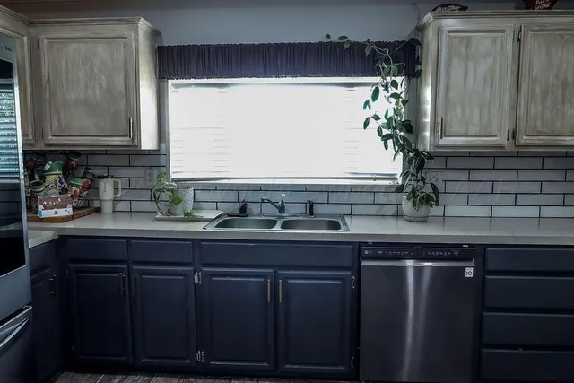 a kitchen with a sink and wooden cabinets