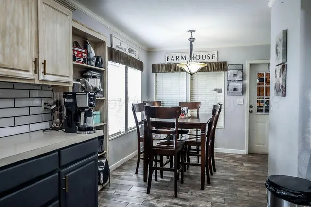 a view of a dining room with furniture and chandelier