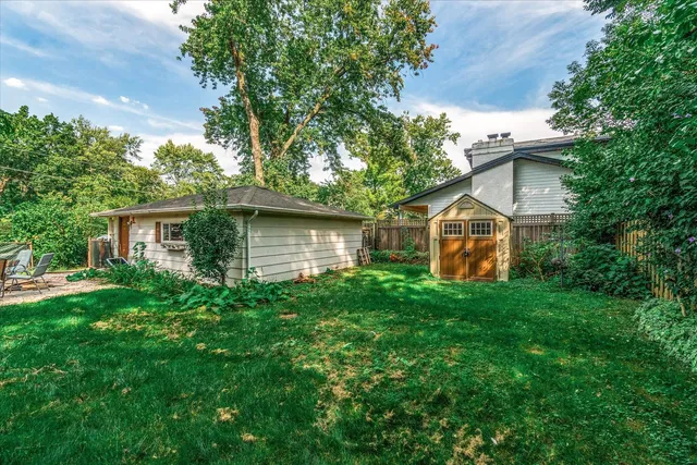 a view of a house with a yard and sitting area