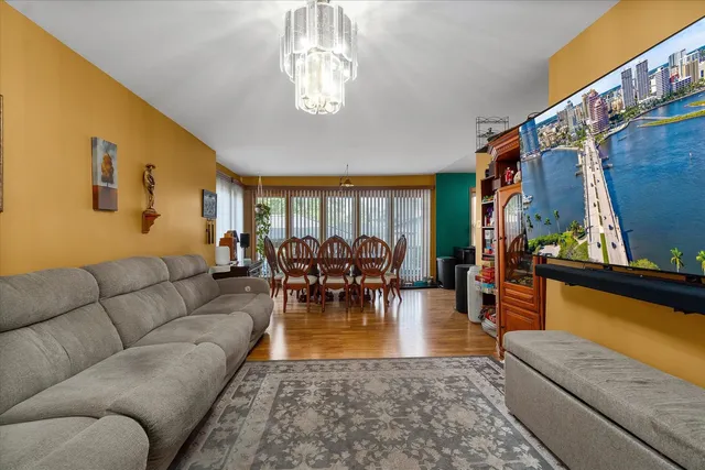 a living room with furniture and a dining table