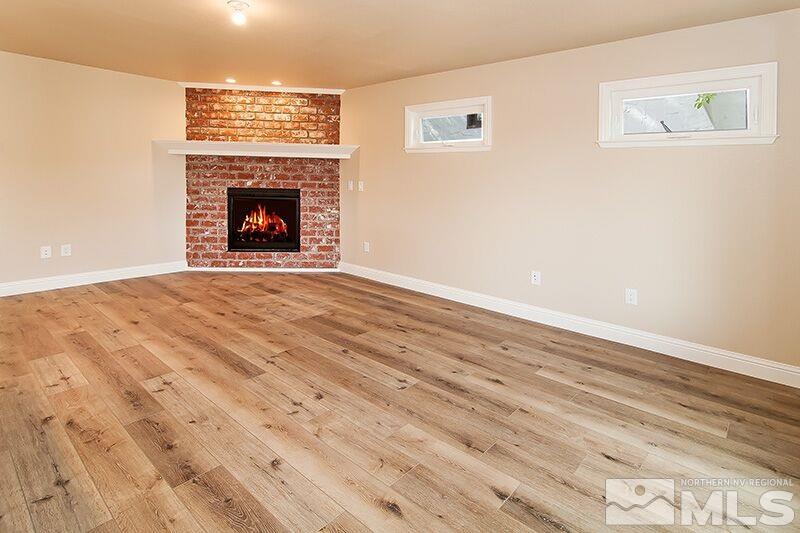 74 Caliente Street Reno, NV 89509 - Photo 5 of 13 a view of an empty room with wooden floor fireplace and a window