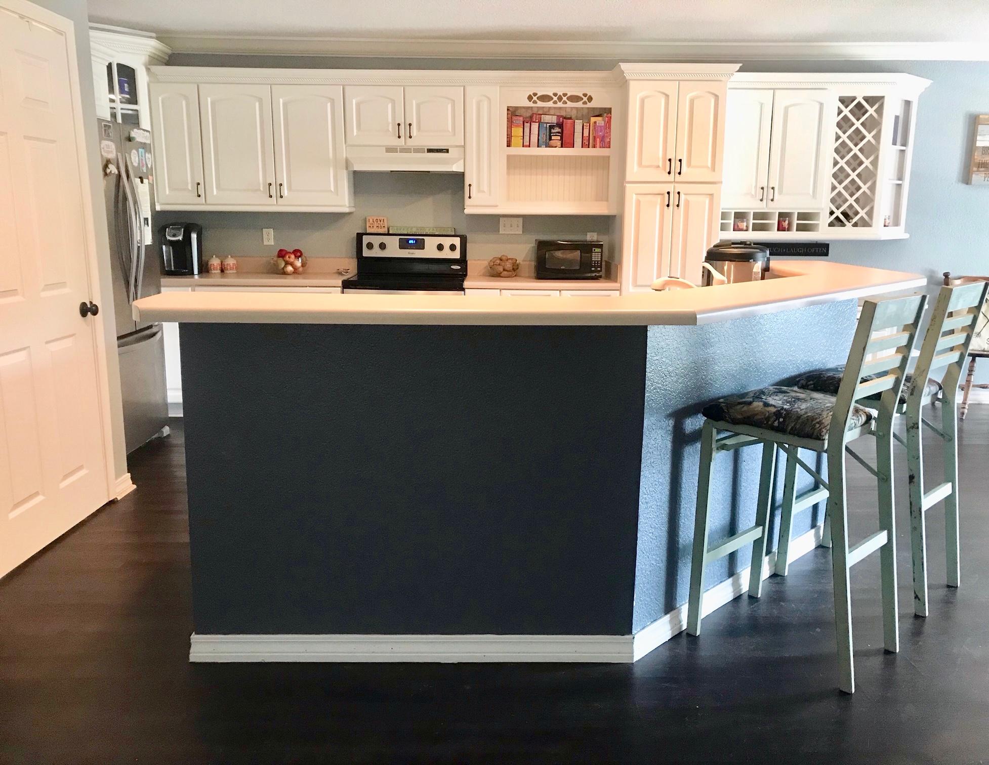 918 Deshazo Road Crestview, FL 32539 - Photo 14 of 28 a kitchen with stainless steel appliances a microwave a sink a stove and white cabinets with wooden floor