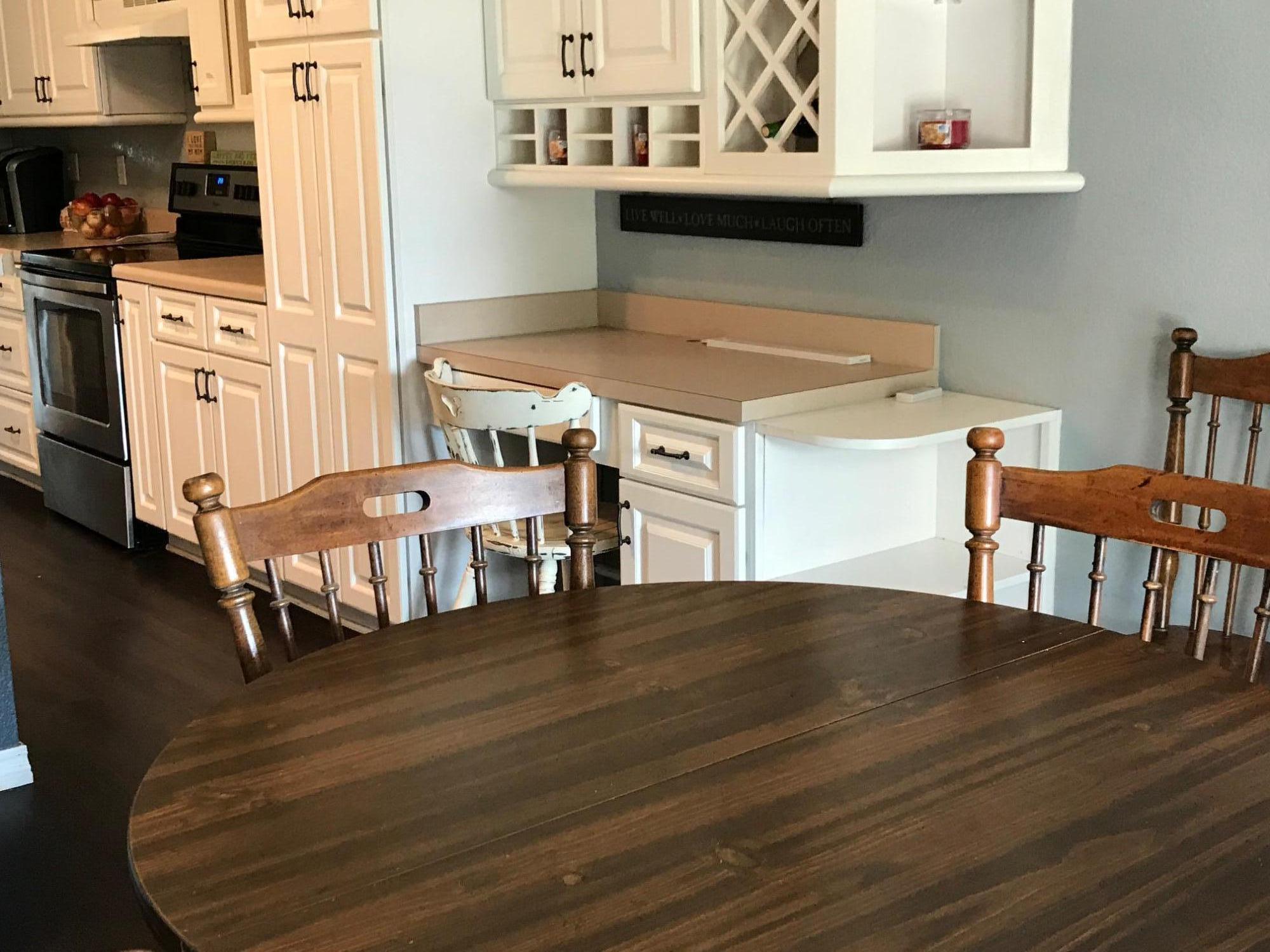918 Deshazo Road Crestview, FL 32539 - Photo 17 of 28 a kitchen with stainless steel appliances granite countertop a stove a refrigerator a dining table and chairs with wooden floor