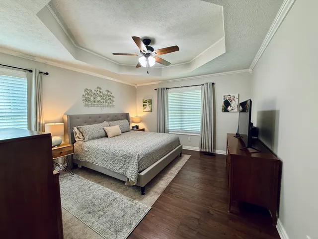 a bedroom with a bed and a chandelier
