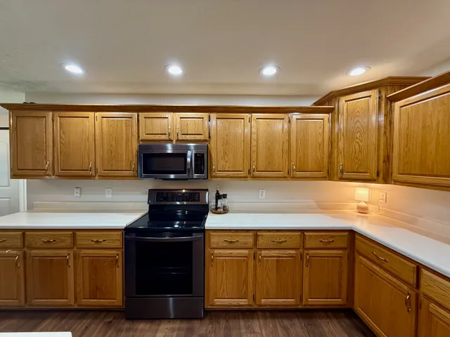 a kitchen with granite countertop a sink and a stove top oven
