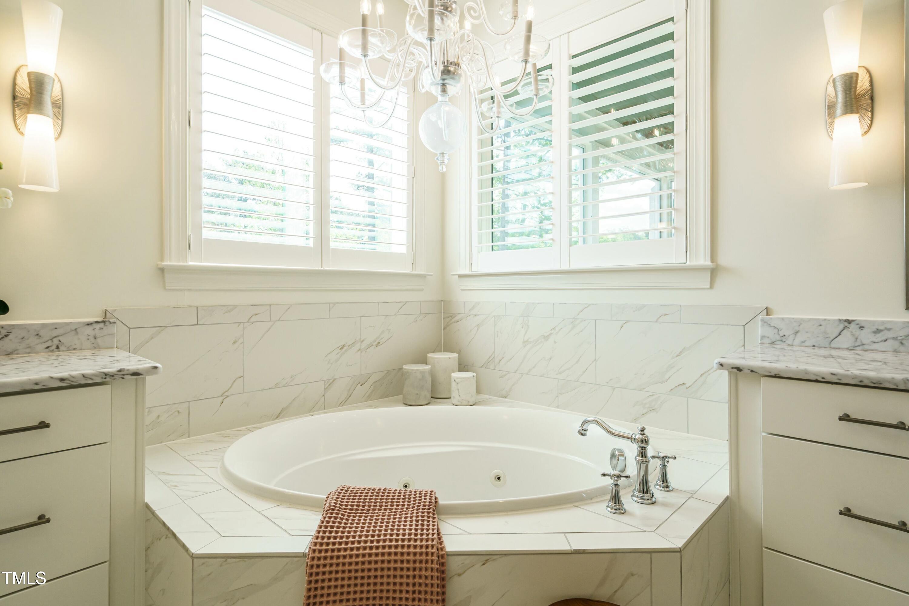 5265 Aleppo Lane Raleigh, NC 27613 - Photo 27 of 45 a bathroom with a granite countertop sink and a bathtub