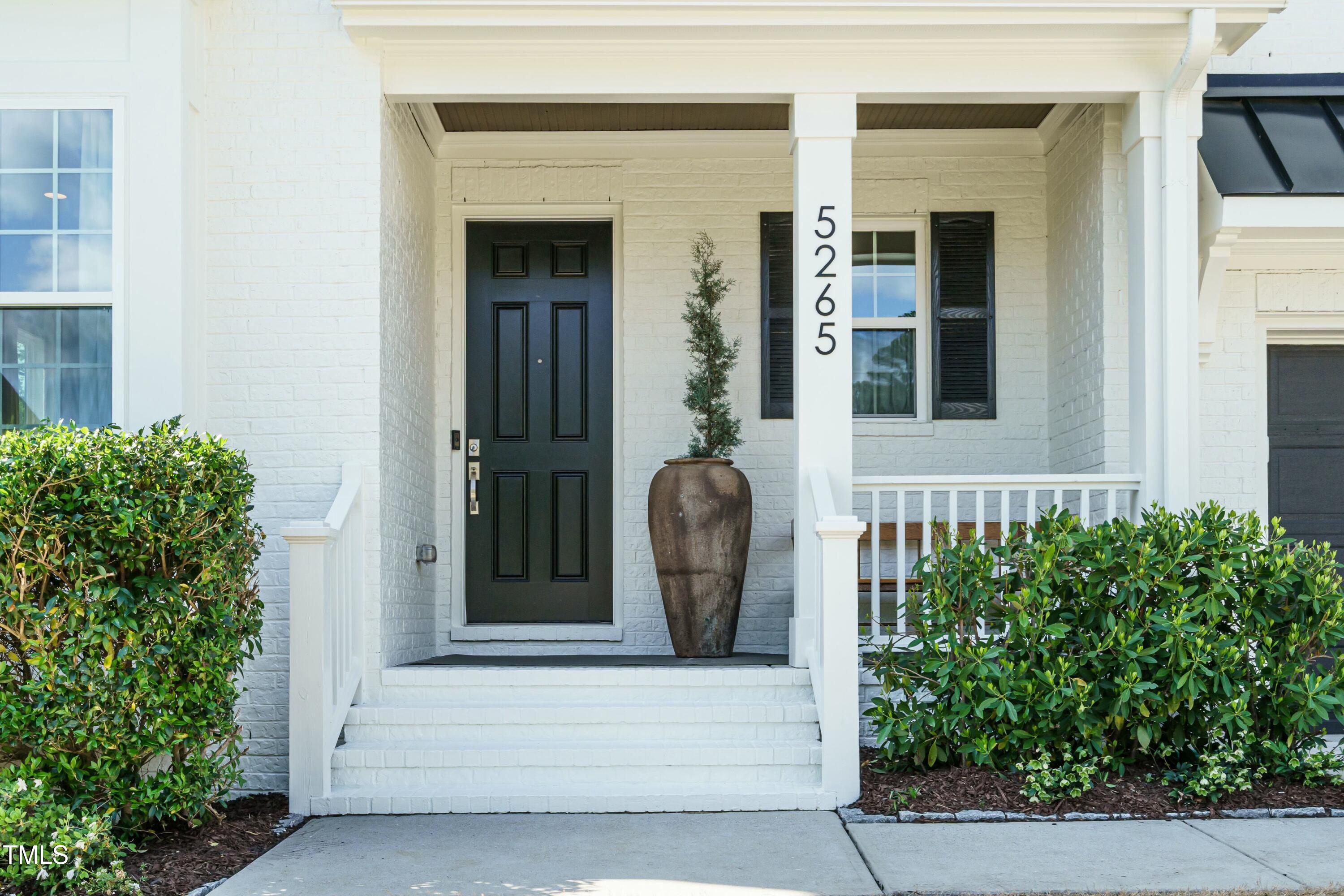 5265 Aleppo Lane Raleigh, NC 27613 - Photo 2 of 45 front view of a house with a potted plant and a window