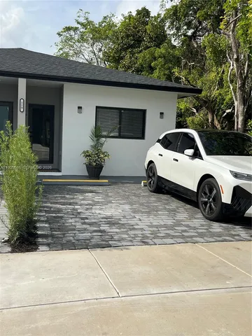 a view of a car parked front of a house
