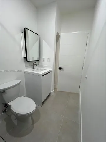 a bathroom with a toilet a sink and mirror