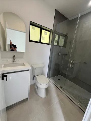 a bathroom with a toilet sink and shower