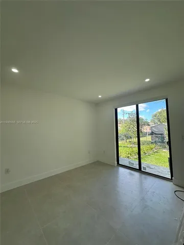 an empty room with an empty space and balcony