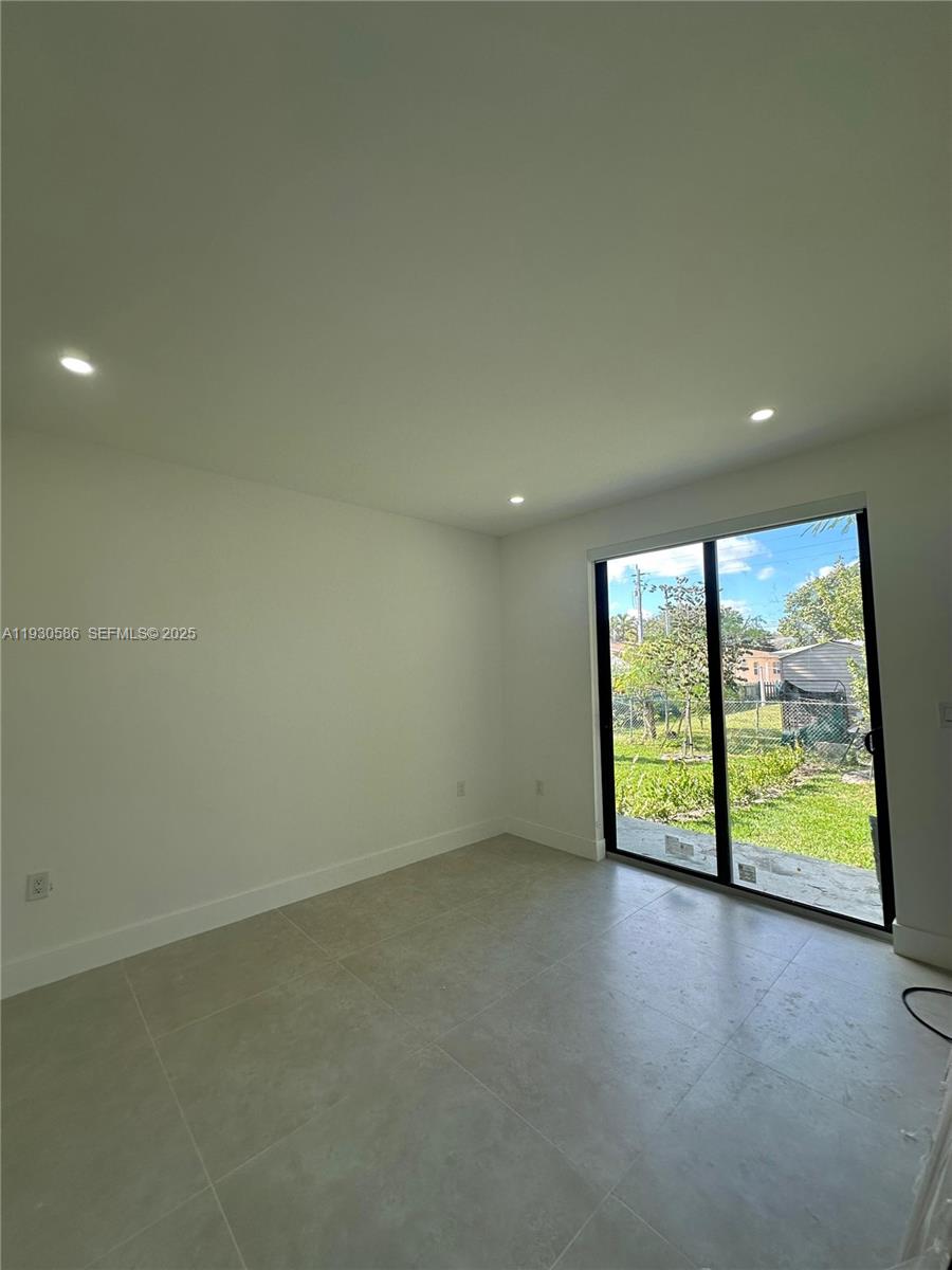 119 Northwest 5th Avenue, Unit 1 Hallandale Beach, FL 33009 - Photo 5 of 5 an empty room with an empty space and balcony