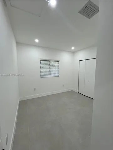 an empty room with a empty space and windows