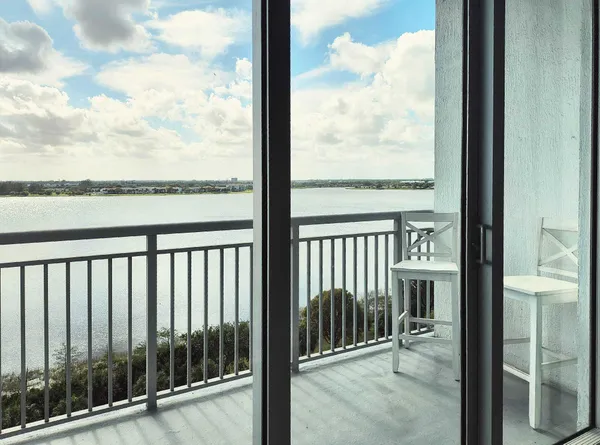 a living room with furniture and large windows