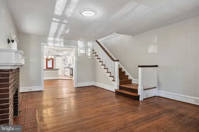 a view of a room with wooden floor and stairs