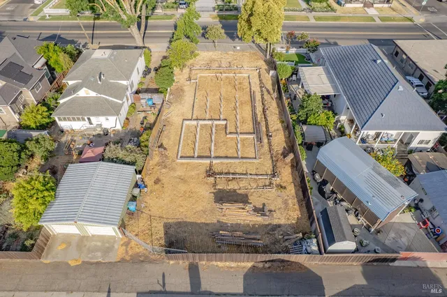 an aerial view of a house with a yard