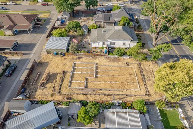 an aerial view of residential houses with outdoor space